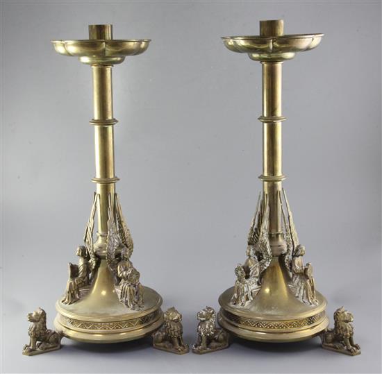 A pair of gothic brass candlesticks, height 22.5in.